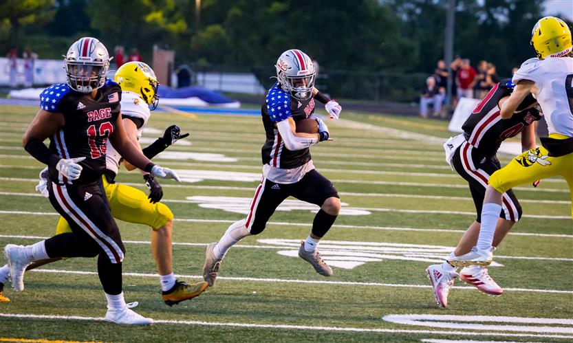 A football player runs the ball